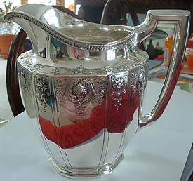 19th Century Tiffany & Co. Pitcher. Circa 1871. Pitcher has paneled sides, and repousse design with shells, scrolls and flowers. Top edge is repousse arrowhead leaf design.