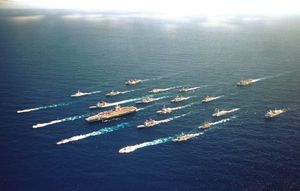 The USS Abraham Lincoln Battle Group along with ships from Australia, Chile, Japan, Canada, and Korea speed towards Honolulu in RIMPAC 2000.