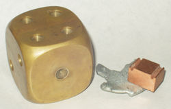 (L-R) Decorative brass paperweight, along with zinc and copper samples